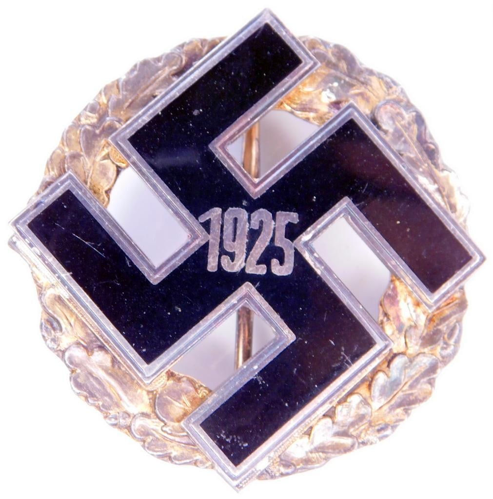 German WWII NSDAP 1925 General Gau Badge: Two piece nickel construction with black enamel. Front shows a swastika with the date 1925 in the center. Surrounded by a round oak leaf wreath. Wide horizontal pin back with a c-catch. Measures 1 13/