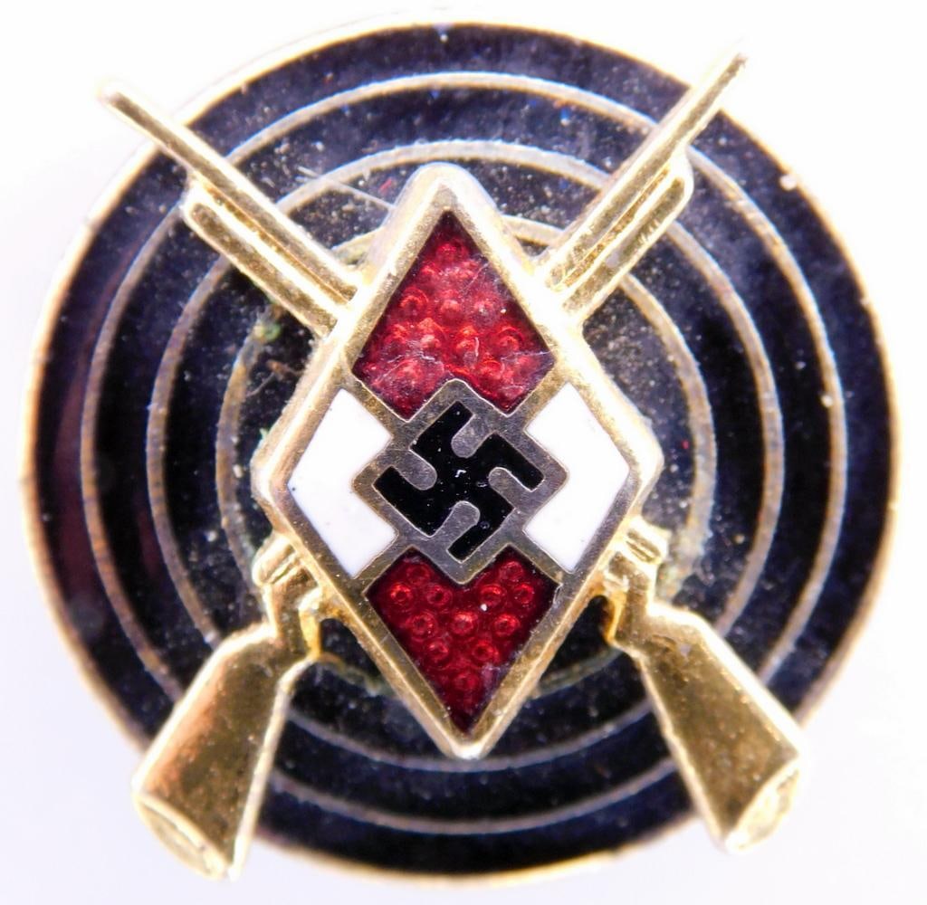 German WWII Senior Gold Hitler Youth HJ Marksman Shooting Badge: Two piece brass construction with enamel. Front shows the Hitler Youth diamond in the center with a pair of crossed rifles behind. Both are mounted onto the front of a bulls eye in the center. Reverse