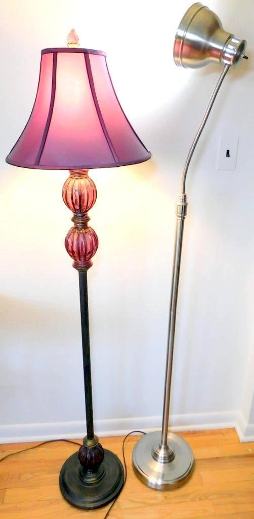 Two Floor Lamps w/ Glass and Metal Construction: You get both shown here for one money This lot includes two floor lamps The first lamp features a purple fabric shade, pink glass orb accents on the stand, and a dark metal base with bronze-like finis