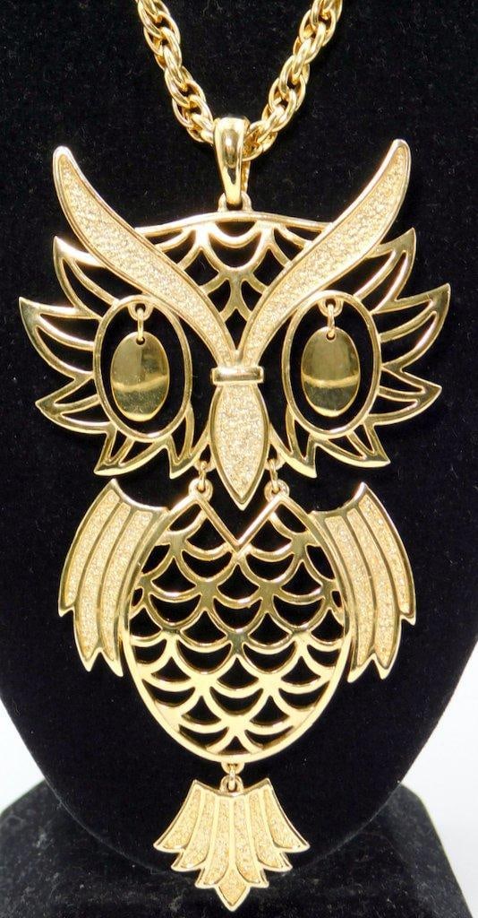 Woman's Costume Jewelry Necklace w/ Large Owl Pendant: Ready to make a statement Gold-tone owl-shaped pendant necklace featuring intricate scrolling details on a large owl design Great looking owl keeping an eye on everyone Look how great it shows Gold-to