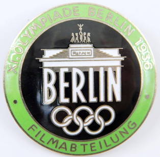Film Maker Badge, 1936 Berlin Summer Olympics: One-piece vaulted nickel construction with green, black and white enamel. Front reads XI. Olympiade Berlin 1936 Filmabteilung Berlin. Brandenburg Gate with the five Olympic rings in the center.