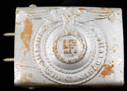 Waffen SS Schutz Staffel EM Belt Buckle: Die-struck stamped steel construction. For an enlisted man. Front shows a Waffen SS eagle clutching a swastika in his talons in the center. Reads Meine Ehre heist Treue! (My Honor is Loyalty!).