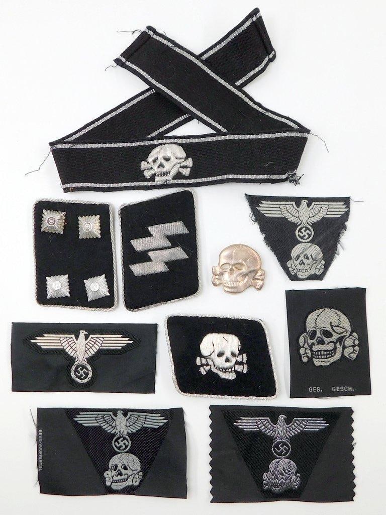 German WWII Waffen SS Cloth Insignia Grouping of Ten (10): Grouping includes: Waffen SS Totenkopf Officers skull cuff title; pair of SS officers collar tabs; cloth SS skull; SS EM trapezoid insignia (2); SS EM eagle; SS officer Trapezoid insignia; SS Officers