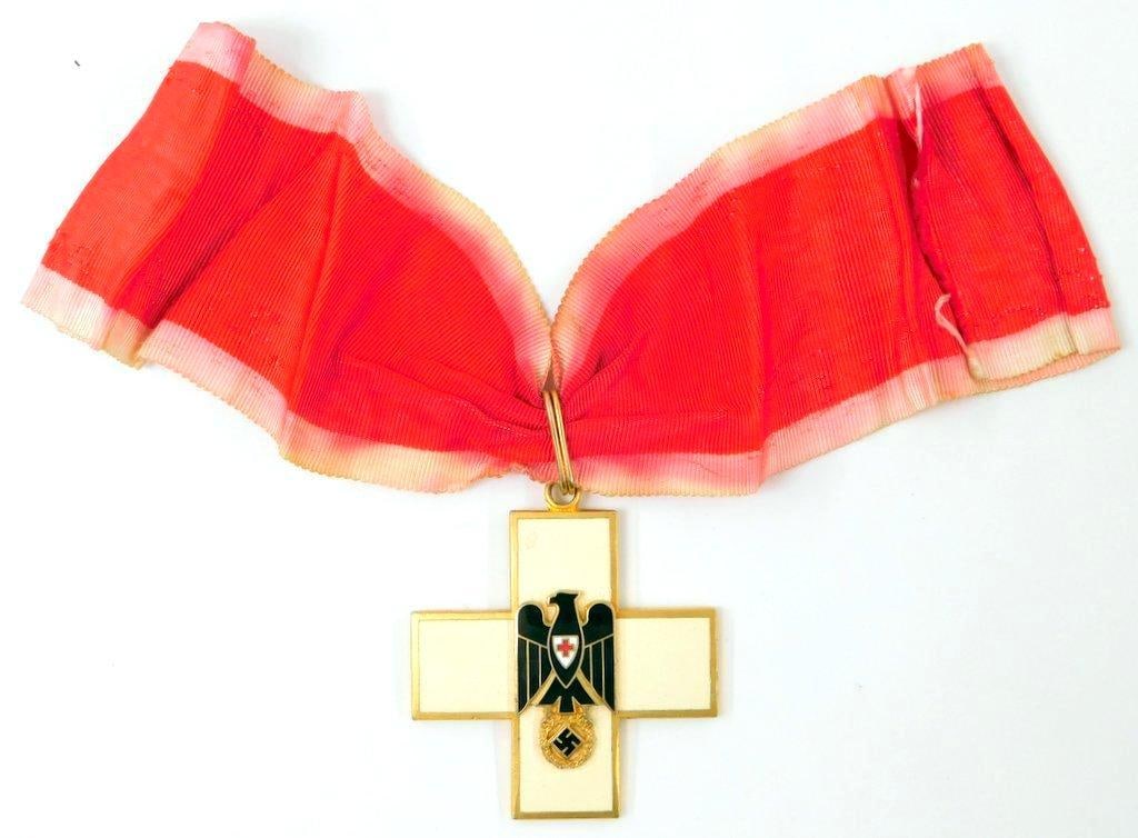 German WWII Social Welfare Neck Order: Two-piece die-struck brass construction with enamel. Front shows an eagle clutching a swastika in his talons. There is a Red Cross in the center of the eagle chest. Reverse is maker marked CHR. BAUER 