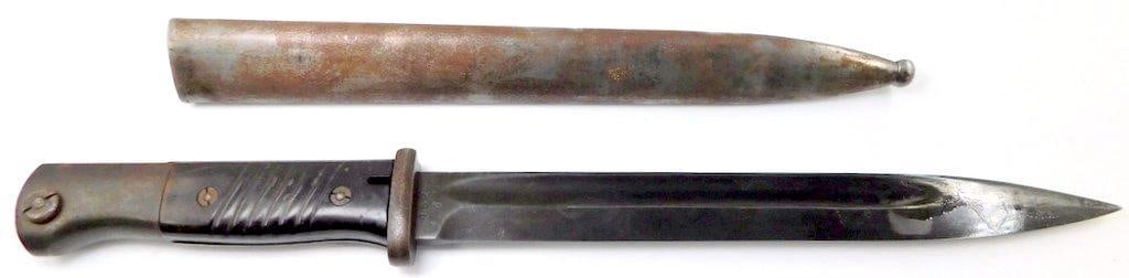 German WWII Mauser K-98 Combat Rifle Bayonet and Scabbard: Measures 16 inches long overall. Blued steel blade is numbered and maker marked 452 d Coppel G.m.b.H. Dated 40 on the top of the spine. Measures 1 inch wide by 9 7/8 inches long. Steel scabbard m