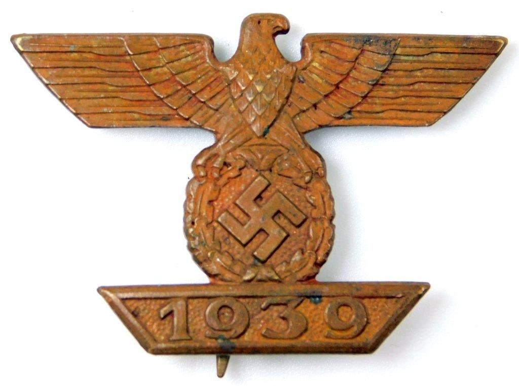 1st Class Clasp to the Iron Cross: One-piece die-struck copper construction. This was awarded for receiving a 1st Class Iron Cross in World War I and World War II for gallantry in combat action. Front shows a German eagle clutching a s