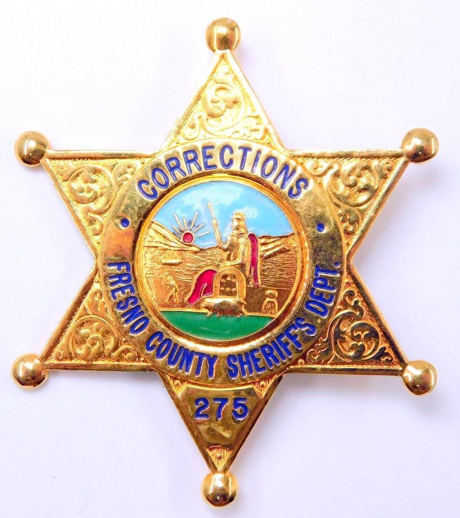 Obsolete Fresno County CA Sheriffs Corrections Police Law Badge: Two-piece die-struck brass construction with six-pointed star. Front shows the California state seal in the center. Reads Corrections Fresno County Sheriffs Depart # 275. Velcro on reverse for attachi