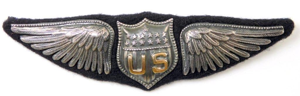 US WWI Aero Dallas Pilot Aviator Wing: Six-piece silver and brass construction with dark blue wool backing. Front shows a shield with the letters US in the center with 13 stars above. Shield is flanked by a wing on each side. Thin horizont