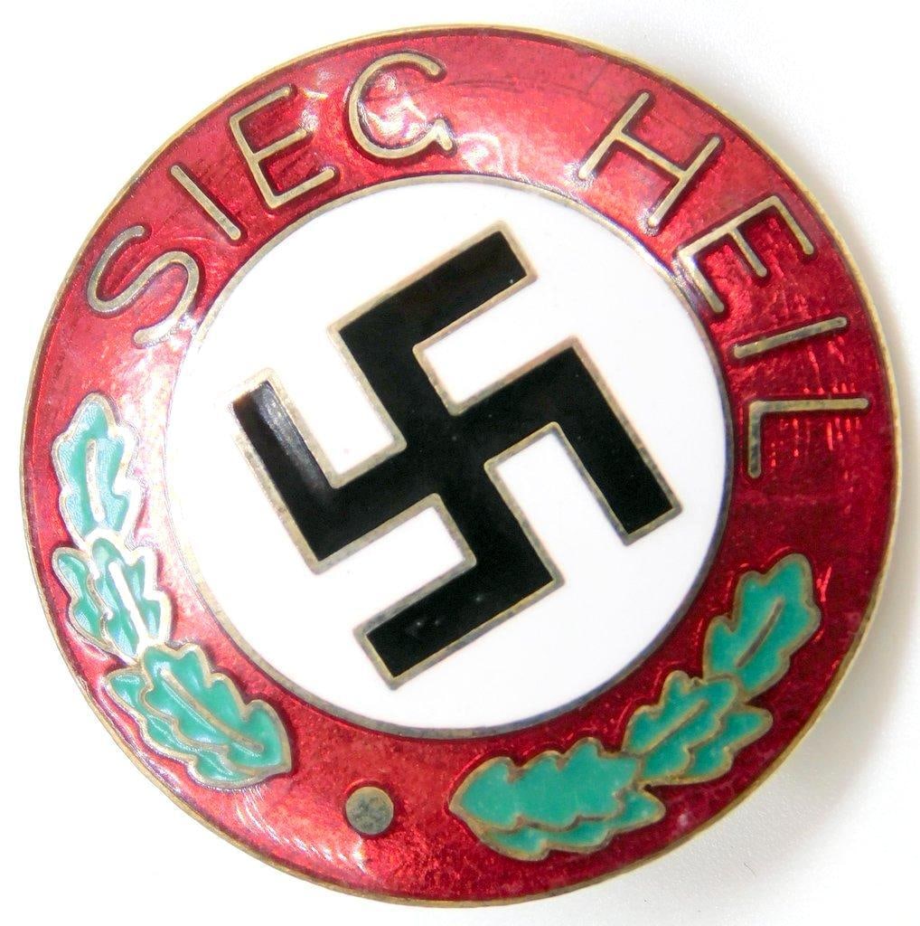 SIEG HEIL Swastika Lapel Badge: One-piece die-struck vaulted nickel construction with enamel. Front shows a swastika in the center. Reads SIEG HEIL. Screw mount post with a brass nut on reverse. Measures 1 1/2 inches in diameter.