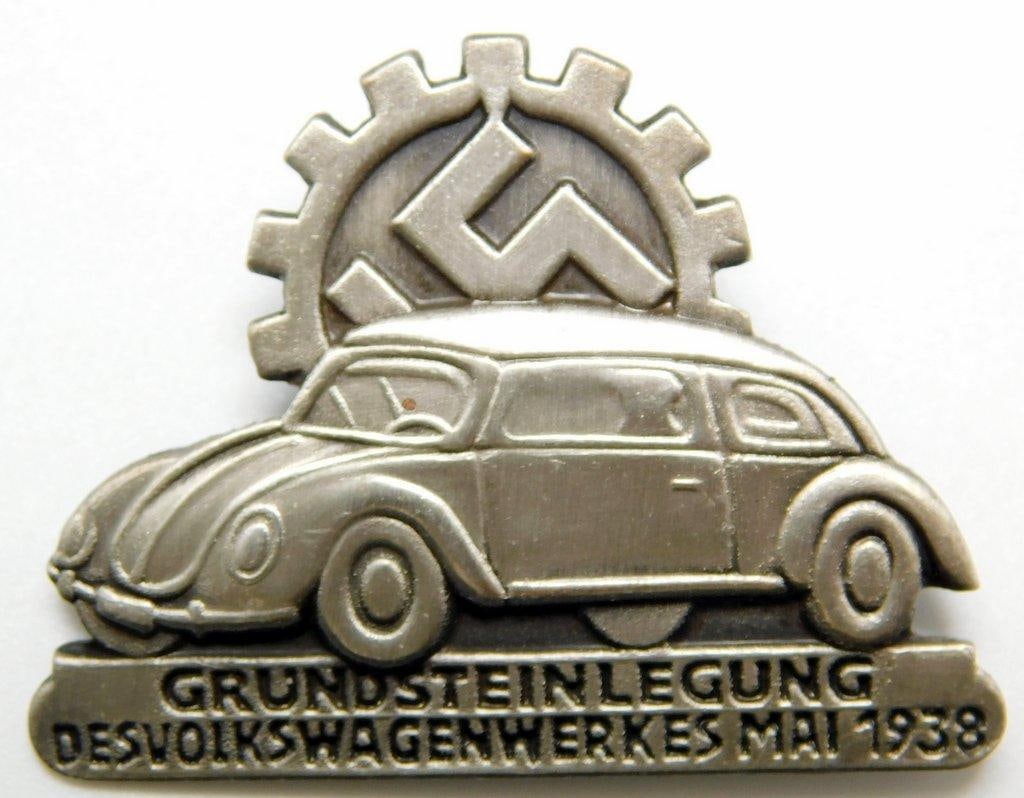 1938 Volkswagen VW Ground Breaking Plant Works Badge: One-piece die-struck nickel construction. Front shows the profile of a VW bug car with a cog wheel at the top. Reads Grendsteinlegung Des Volkswagenwerkes Mai 1938 on the base. Reverse is maker-m