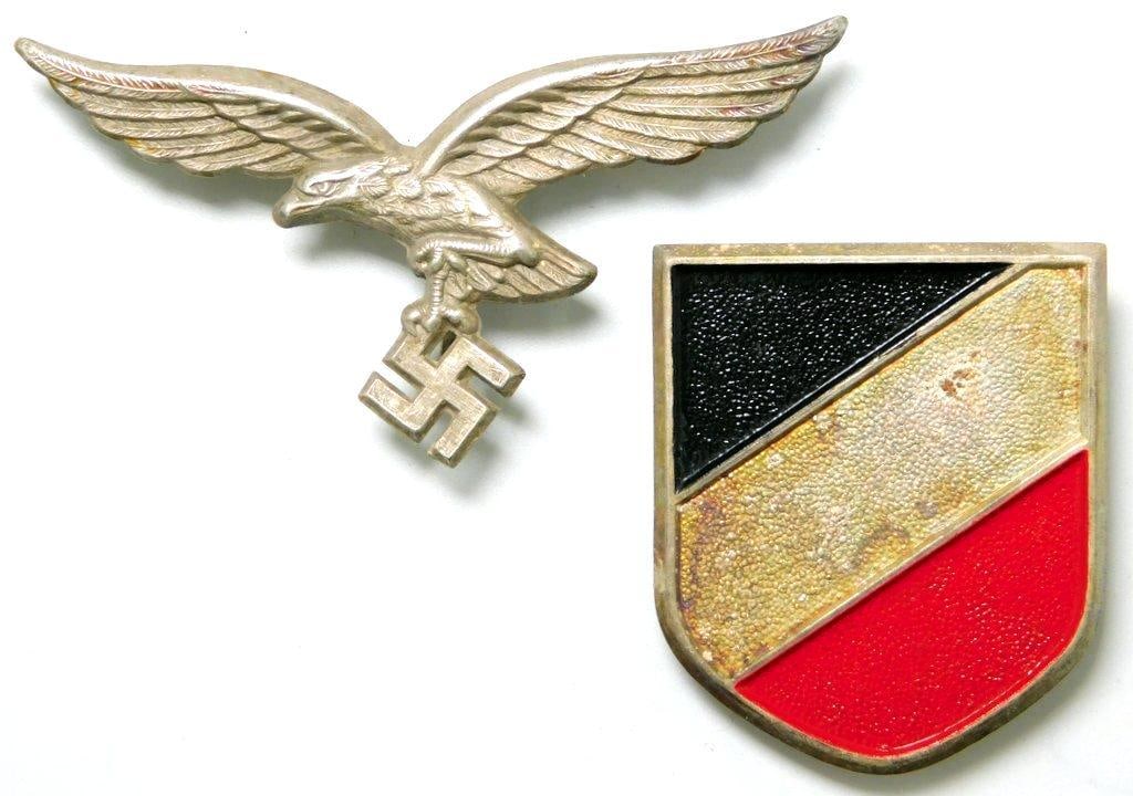 German WWII Luftwaffe Afrika Korps Pith Helmet Eagle and Shield: Stamped nickel construction. Field Marshal Erwin Rommel was in command of this elite division of combat troops. Front shows a Luftwaffe flying eagle clutching a swastika in its talons. Measures 2 5/8 