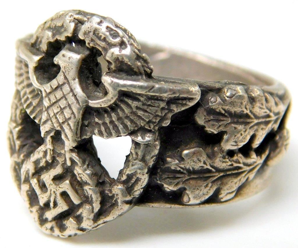 German WWII Police POLIZEI Officers Ring: Appears to be silver construction. Front shows a spread-winged police eagle clutching a swastika in its talons. Both are surrounded by an oval oak leaf wreath. There are two oak leaves on each side. T