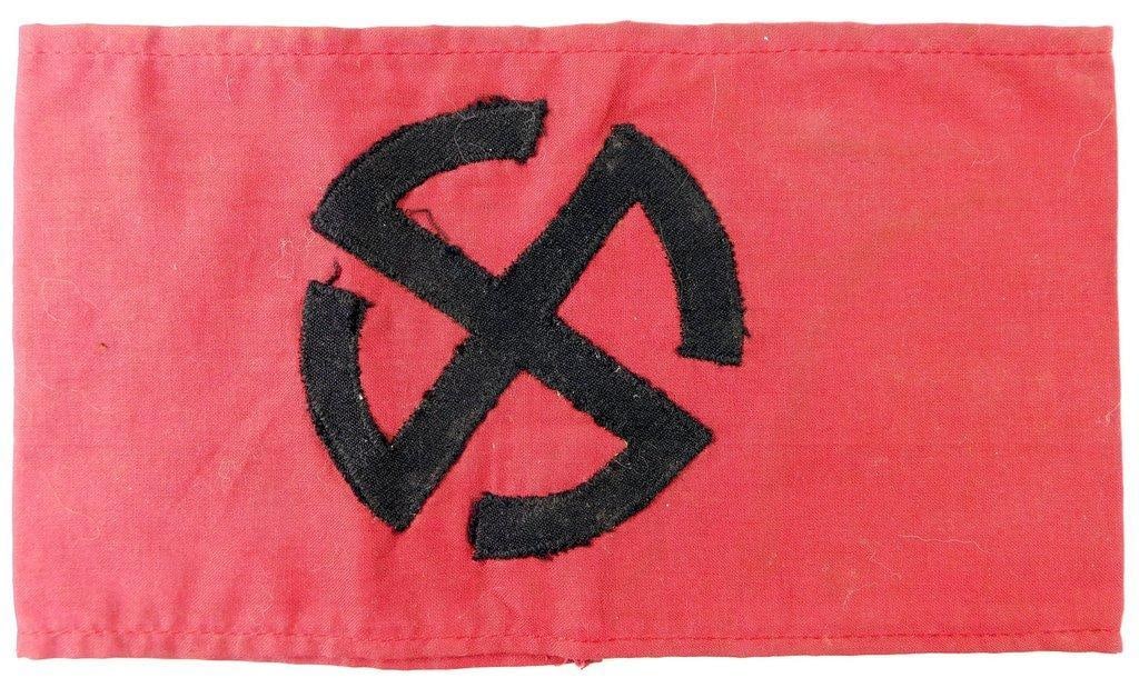German WWII Foreign Volunteer Swastika Arm Band: Two-piece machine-sewn cotton construction. This was to have been worn on the upper left sleeve of the uniform. Front shows a cog wheel swastika in the center. Measures 8 3/4 inches wide by 4 7/8 inch