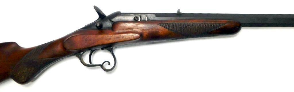 Belgian Flobert .22 Caliber Rimfire Parlor Rifle: Beautiful rifle with octagon barrel with breech lock hammer, designed for indoor saloon target shooting Features a wood stock with fine checkering on the grip and forearm The receiver is mar