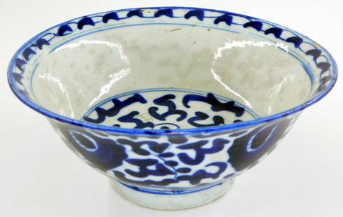 Antique Chinese Blue and White Ceramic Bowl w/ Underglaze Decoration and Mark: A ceramic bowl, decorated with blue underglaze floral and abstract motifs on a white background The base is marked with a blue underglaze stamp The bowl shows some wear consistent with age and use, in