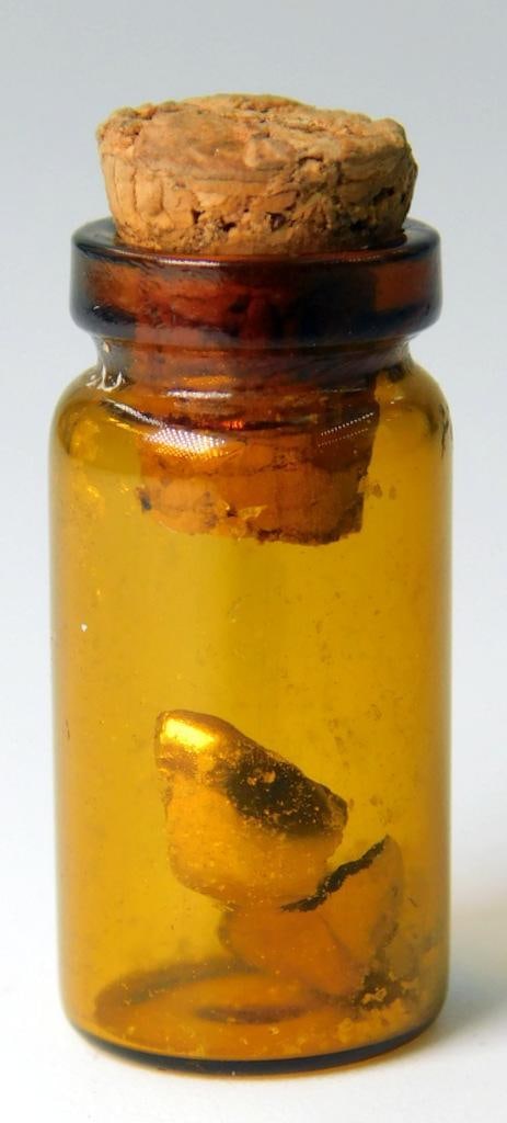 22K Yellow Gold Scrap Piece: Dental piece of scrap gold Tested 22K gold Includes small brown glass bottle as found Weighs .55 dwt 