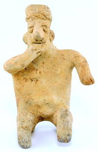 Pre-Columbian Jalisco Ceramic Pottery Seated Figure Of A Man: Pre-Columbian style seated clay figure, featuring intricate facial details including a prominent nose, headdress, and hand gestures Tomb figure made of terracotta Is seated but not well balanced when