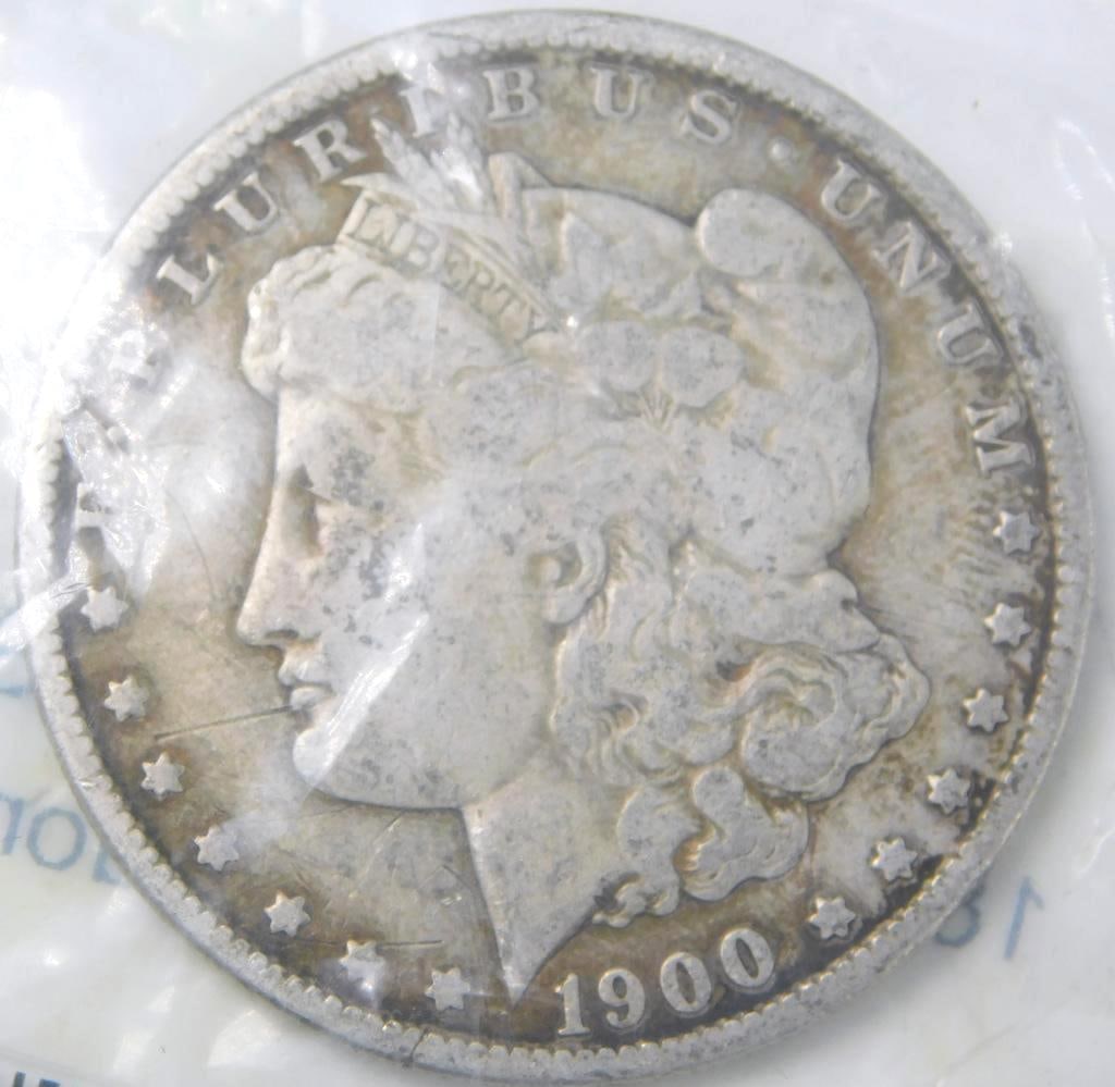 1900 O Morgan Silver Dollar Coin: Designed by George T. Morgan, with circulated condition In APMEX plastic bag
