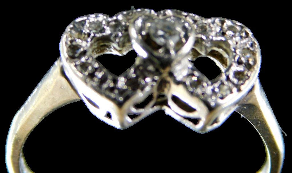 Ladies 10K Gold and Diamonds Heart Ring: Showing two larger heart shaped design with a connecting smaller heart with diamond center Diamond tested positive Marked 10K GTR Size 7 1/4 1.35 dwt Shows well