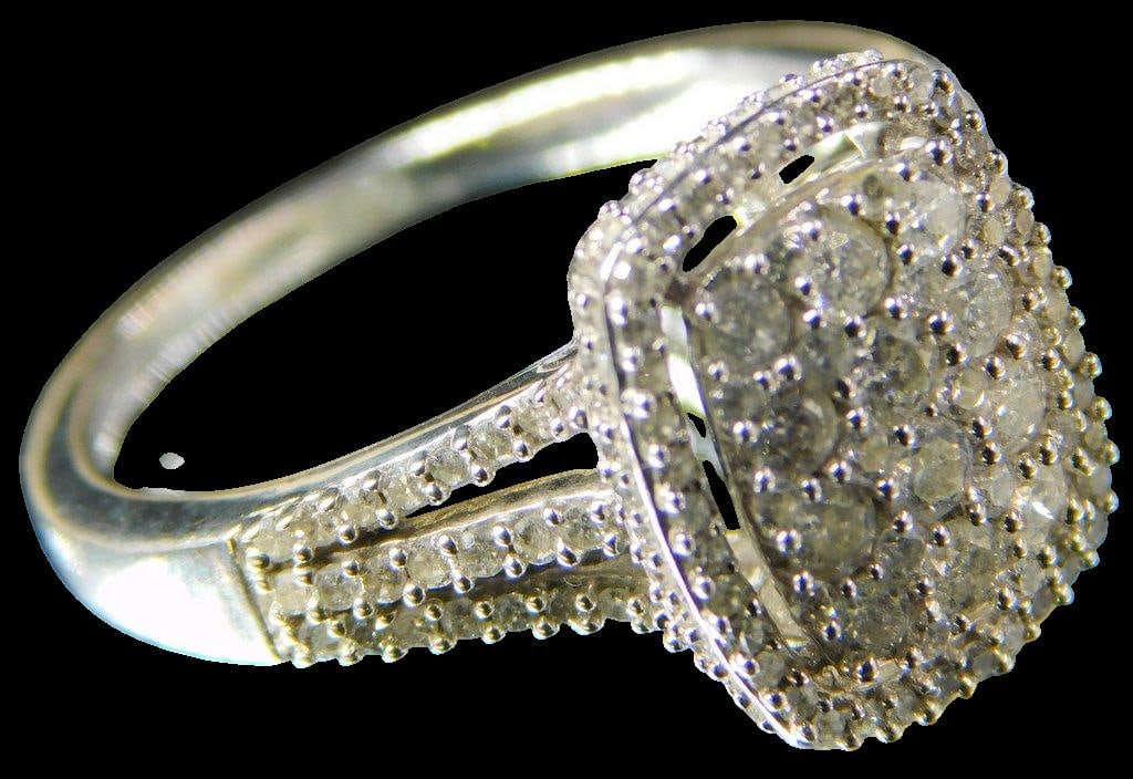 Diamond and Sterling Silver Ladies Ring: Diamond cluster ring, ready to enjoy Look how great this shows Many diamonds make us this show off piece Diamond tested SS tested, non-magnetic Marked KRN Size 8.25 3.4 dwt