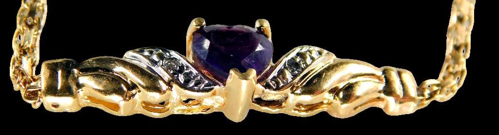 14K Gold Bracelet w/ Amethyst Heart and Diamond Accents: 14K yellow gold bracelet featuring a central heart-shaped amethyst stone flanked by textured leaf motifs with diamond accents The chain is a delicate link style with a spring ring clasp, marked 14K