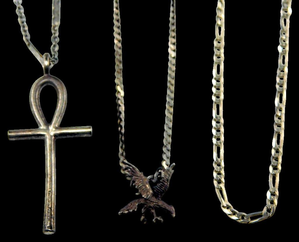 Three Sterling Silver Necklaces Including Ankh and Eagle Pendants: Three sterling silver necklaces, including one featuring an Ankh pendant marked Sterling another with an eagle motif, and a plain chain necklace All are crafted in sterling silver with varying chain
