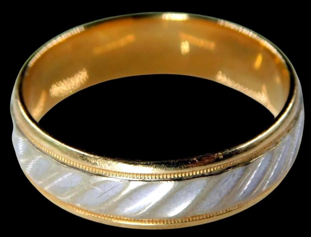 14K Gold Band Ring w/ White Inlay Design: 14K gold band ring with interior engraving marked 14K F_ Features a white inlay design with a textured appearance, framed by narrow gold edges The ring shows signs of natural wear Material is14K