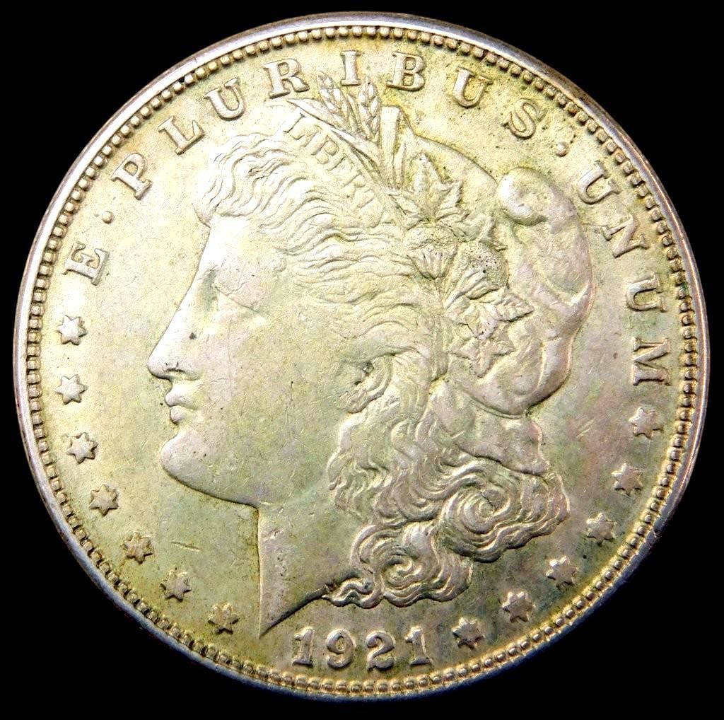 1921 Morgan Silver Dollar Coin: 1921 Morgan Silver Dollar The reverse features an eagle design, partially obscured by an old tape strip marked 6-7$ Coin appears lightly circulated with visible details