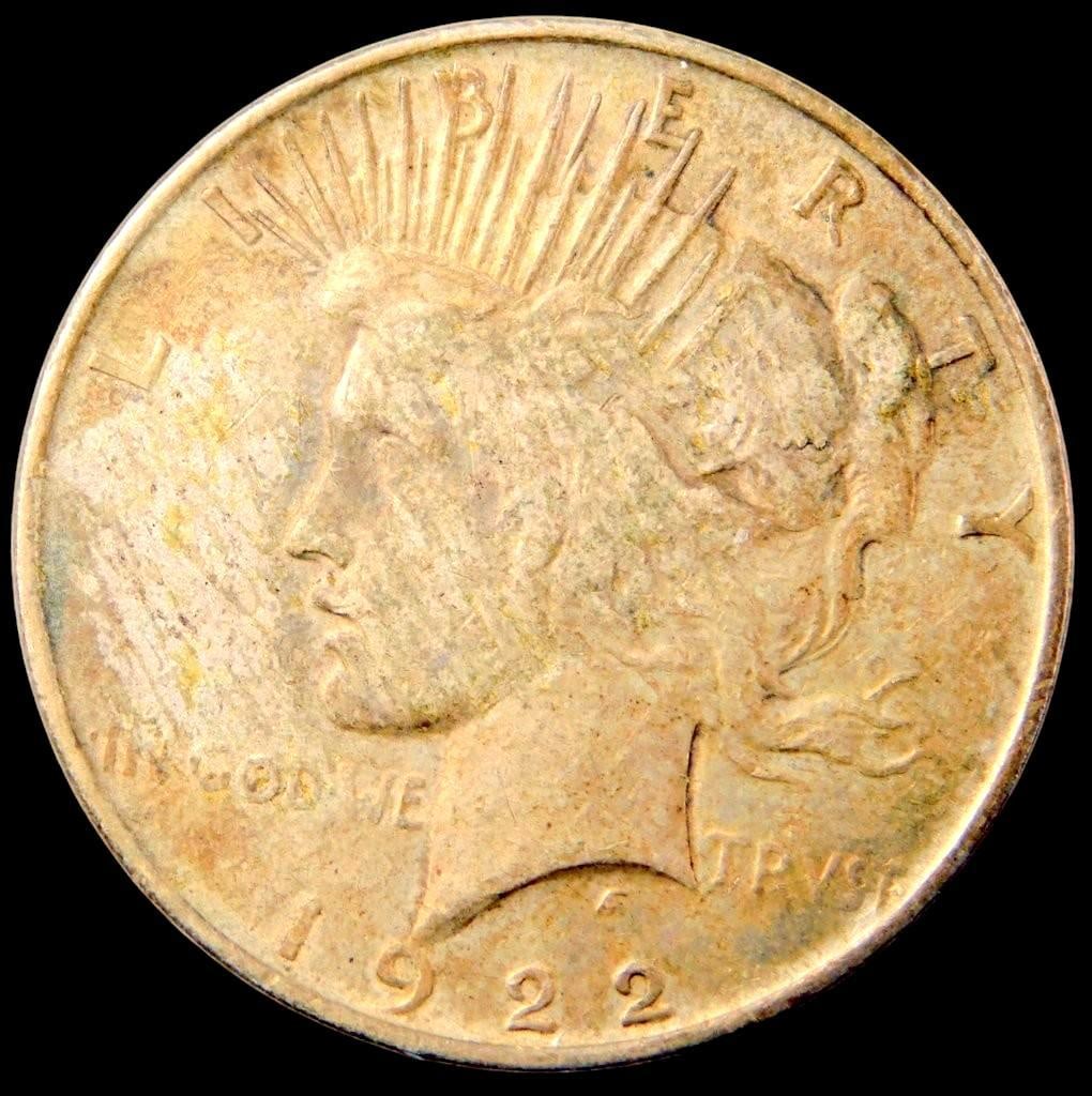 1922 Peace Silver Dollar Coin: 1922 Peace Dollar Features the iconic profile of Liberty on the obverse and an eagle with the inscription Peace on the reverse Shows moderate wear indicative of circulated condition 