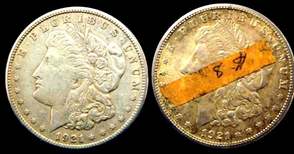 Two 1921 Morgan Silver Dollar Coins: Two 1921 Morgan Silver Dollars Both coins exhibit clear design details on obverse and reverse Note the presence of adhesive tape markings on one side of each coin as found Both are circulated