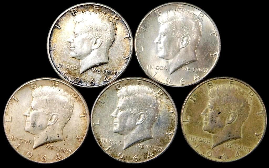 Five 1964 Kennedy Half Dollar Coins: Five 1964 Kennedy Half Dollar coins composed of 90% silver These coins feature the Kennedy portrait on the obverse and the presidential seal on the reverse Each is from Philadelphia Mint Some show