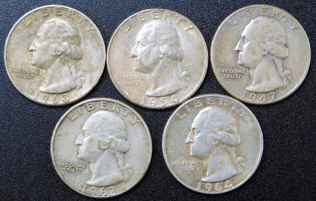 Five 90% Silver Washington Quarters, 1954-1964: Five circulated 90% silver Washington quarters, dated as follows: 1954, 1947, 1962, 1963, and 1964 The obverse features the profile of George Washington, while the reverse has an eagle with a shield