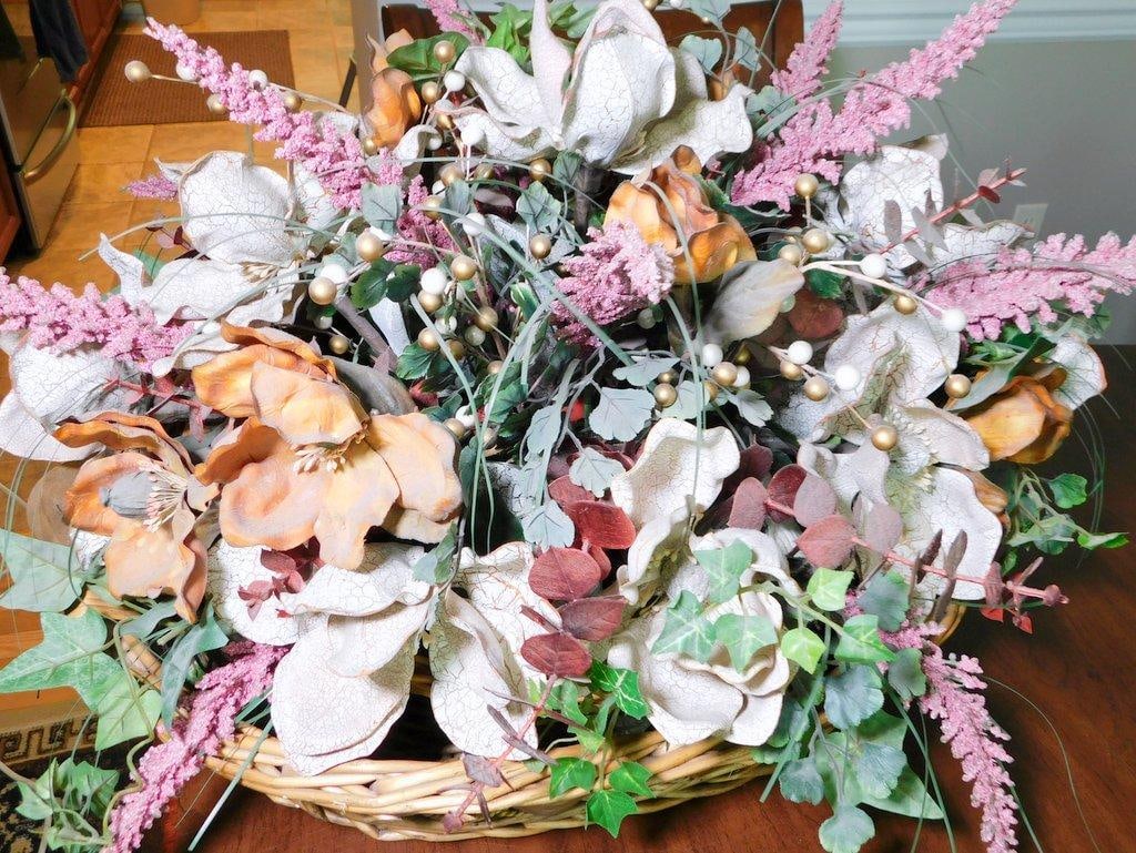 Handcrafted Artificial Floral Arrangement in Woven Basket: A handcrafted artificial floral arrangement featuring white crackled texture flowers, peach blooms, and various greenery, accented by ivory and gold faux berries Housed in a sturdy and decorative