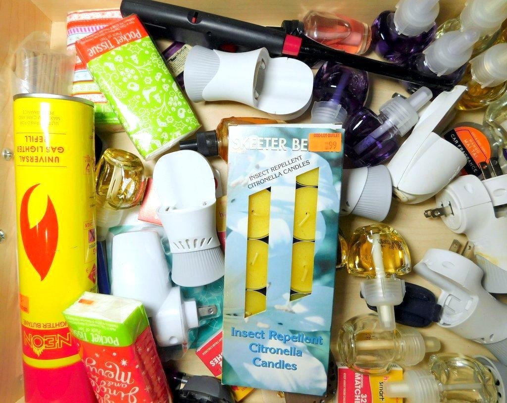 Air Wick Refills, Plug-In Warmers, Citronella Candles, and Accessories: Various Air Wick scented oil refills, plug-in warmers, Skeeter Beater citronella candles (pack of three), a Neon lighter butane refill, matchboxes, pocket tissues, and a black utility tool Items