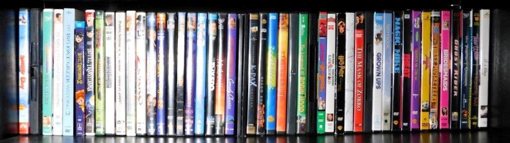 DVDs, Including Comedy, Animation, and Adventure Genres: A diverse collection of DVDs spanning various genres, including animated titles like Hotel Transylvania 2, family comedies such as My Big Fat Greek Wedding 2, action films like The Mask of Zorro, and