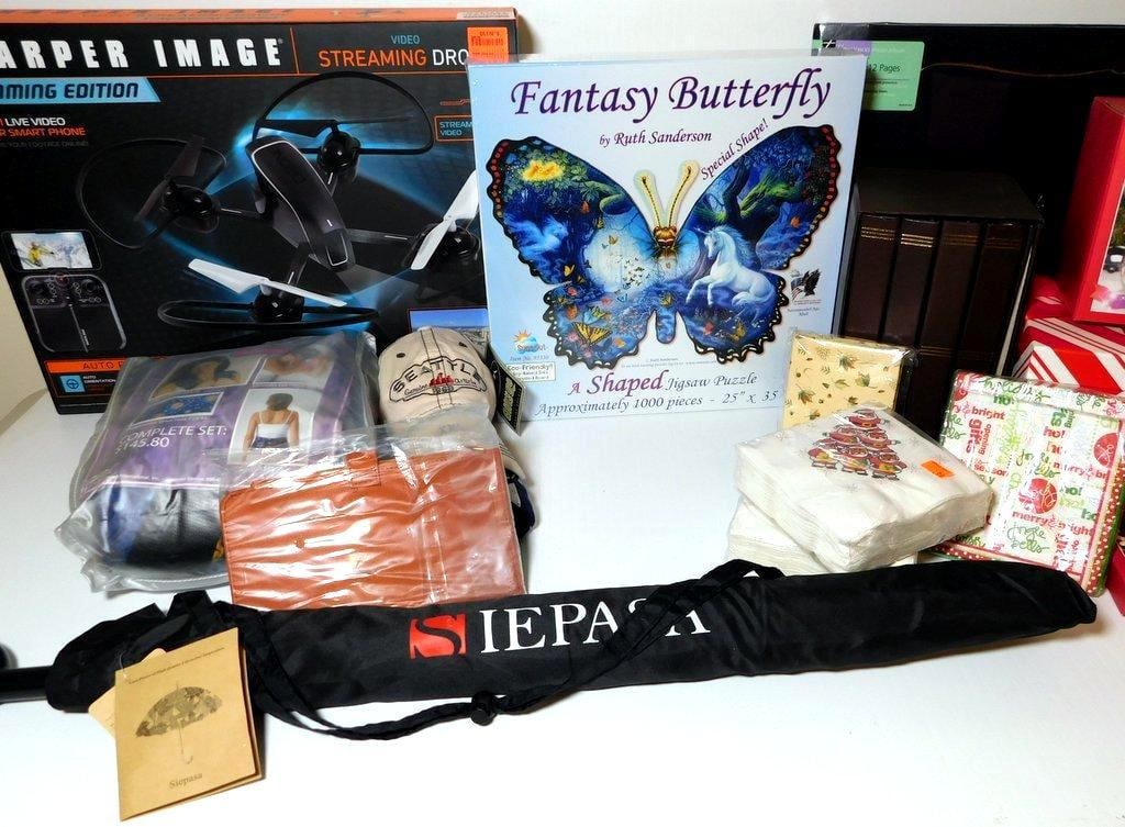 Lot Featuring Sharper Image Drone, Home Spa Set, and Decorative Items: Lot including a Sharper Image Streaming Edition video drone, Nature's Approach Complete Home Spa set, Fantasy Butterfly 1000-piece jigsaw puzzle, an orange leather wallet, a Thompson Photo Album with