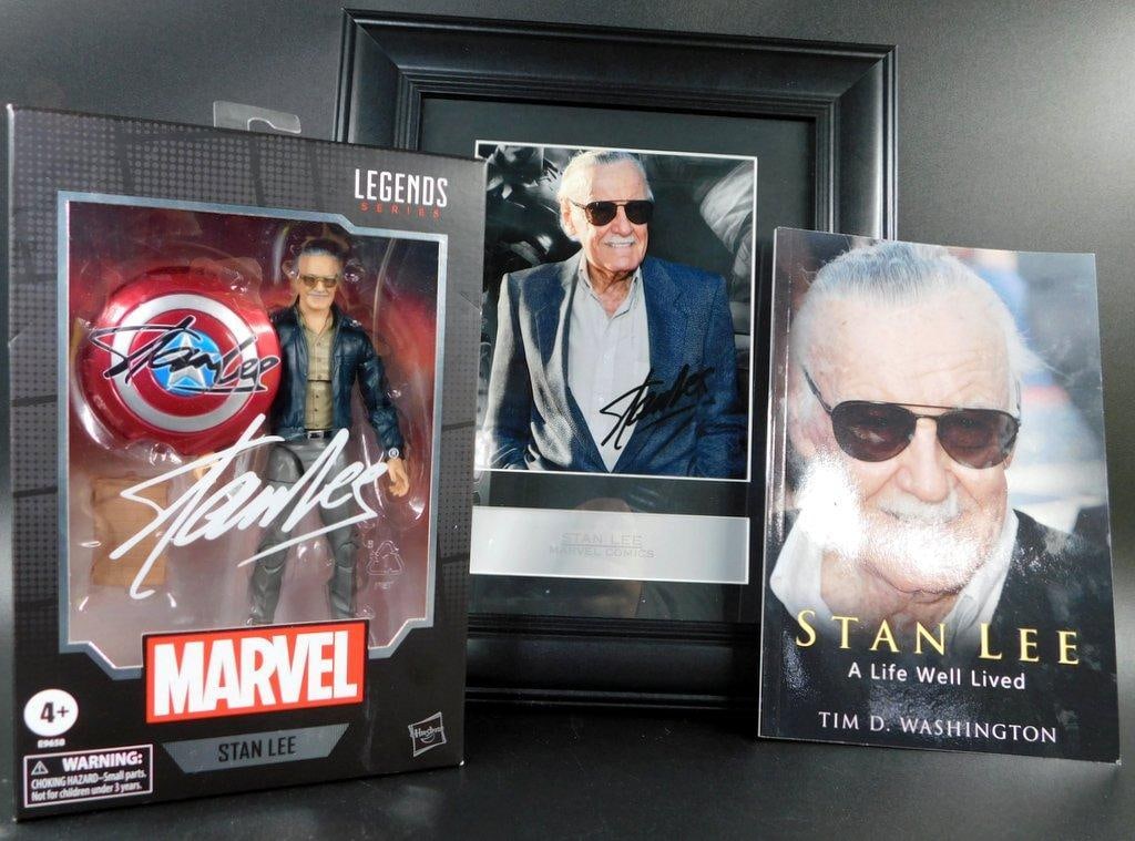 (Lot of 3) Stan Lee Collection- Photo, Book and Action Figure: (Lot of 3) Stan Lee Collection- Photo, Book and Action Figure Stan Lee photo with pre-printed signature and plaque in frame. 8 x 10 inch Desk stand needs repair 80th Anniversary Stan