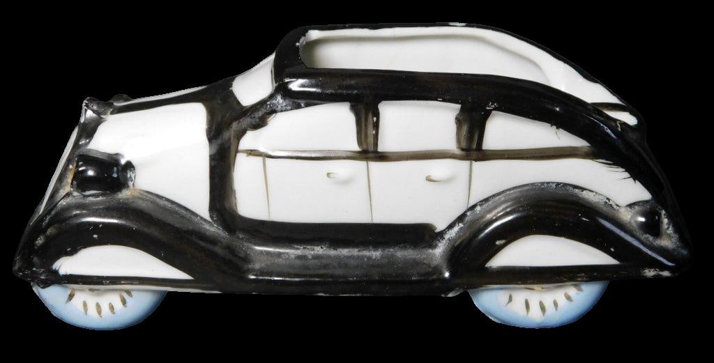 Made in Japan Ceramic Black-and-White Car Figurine Ashtray: Ceramic novelty car ashtray from the mid-20th century featuring a white body with hand-painted black streamline trim and blue wheels Very good condition Ready to collect and display 5 3/4 inches L