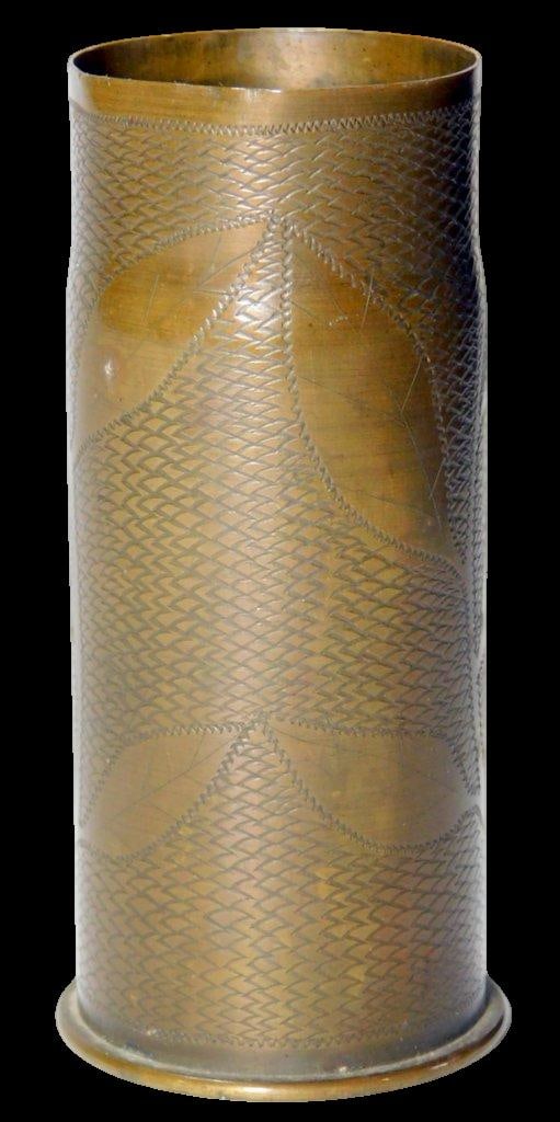 World War I Trench Art Brass Shell Case, 1918: World War I-era brass shell casing, repurposed as trench art The exterior features detailed hand-engraved decorations with a leaf-like pattern and a personalized inscription: Maurice H. Hall to