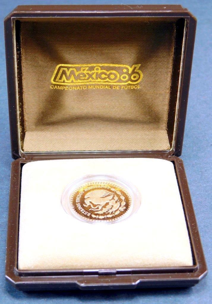 1986 Mexico 250 Pesos Gold Proof Coin in Original Case w/ COA: 1986 Mexico 250 Pesos gold proof coin commemorating the 1986 World Championship of Football Minted by the Mexico City Mint, the coin is 23 mm in diameter, weighs 8.640 grams, and is composed of .900