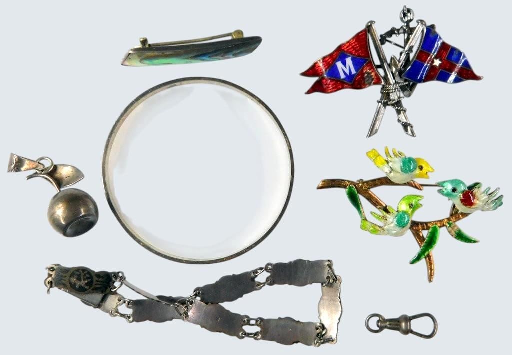 Sterling and Enamel Jewelry Pieces Grouping: Grouping comprising various sterling silver and enamel jewelry items, including a sterling pin with enameled crossed flags, a whimsical enameled brooch featuring birds on a branch, a sterling apple ch