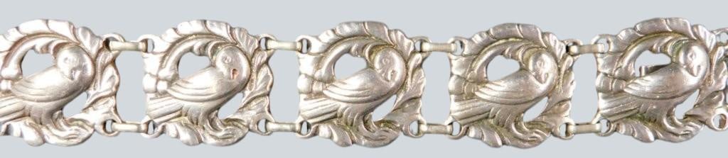 Sterling Silver Link Bracelet w/ Bird Motif: Sterling silver bracelet featuring multiple links, each adorned with a detailed bird design surrounded by a decorative wreath Attractive jewelry, ready to show off The reverse of the clasp is stamped