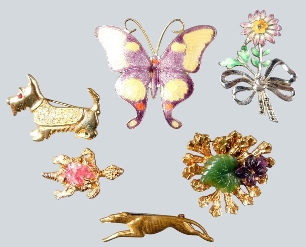 Gold Tone and Enameled Brooches w/ Animal and Floral Designs Included Designer Signed: Six pins and brooches, featuring various designs including a butterfly, dog, turtle, leaping dog, floral bouquet, and floral wreath Materials include enamel and gold-tone metal with decorative