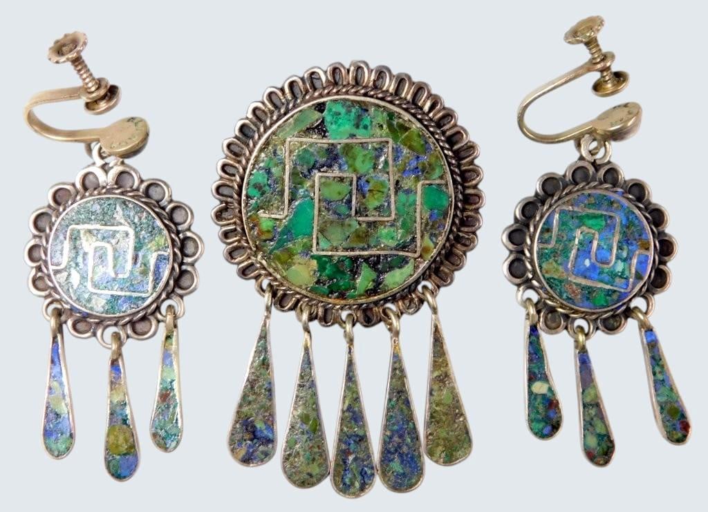 Taxco Sterling Silver Brooch and Earrings Set w/ Turquoise Inlay: Taxco sterling silver jewelry set featuring a brooch and matching clip-on earrings Each piece is adorned with a vibrant turquoise inlay featuring geometric designs and accented with dangling silver