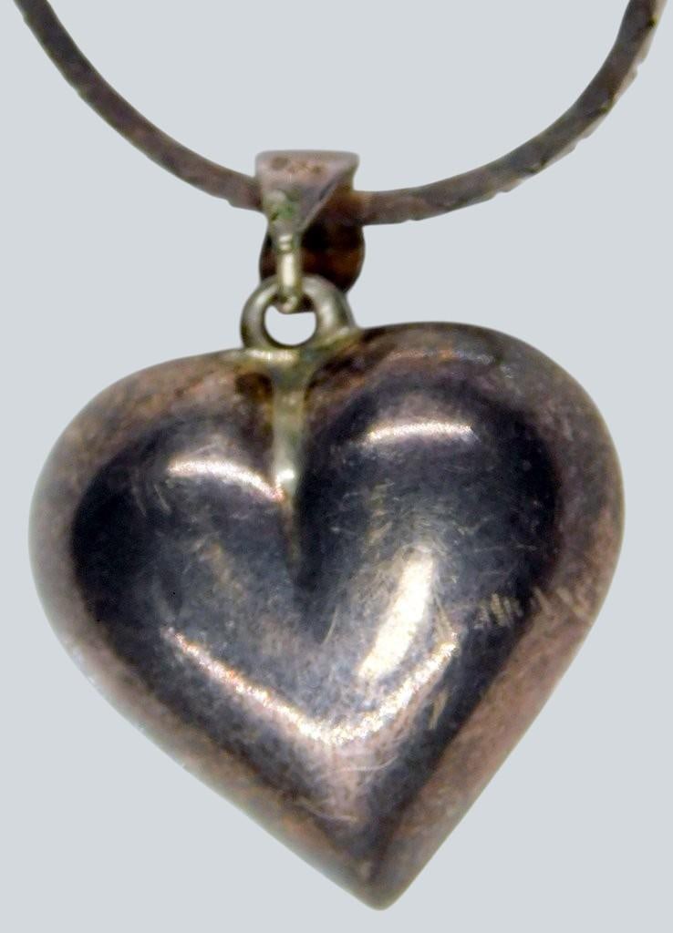 Sterling Silver Heart Pendant Necklace, Marked 925, Italy: Sterling silver necklace featuring a heart-shaped pendant The chain is marked with 925 indicating sterling silver content and stamped Italy, suggesting its origin The clasp and pendant bale also bear