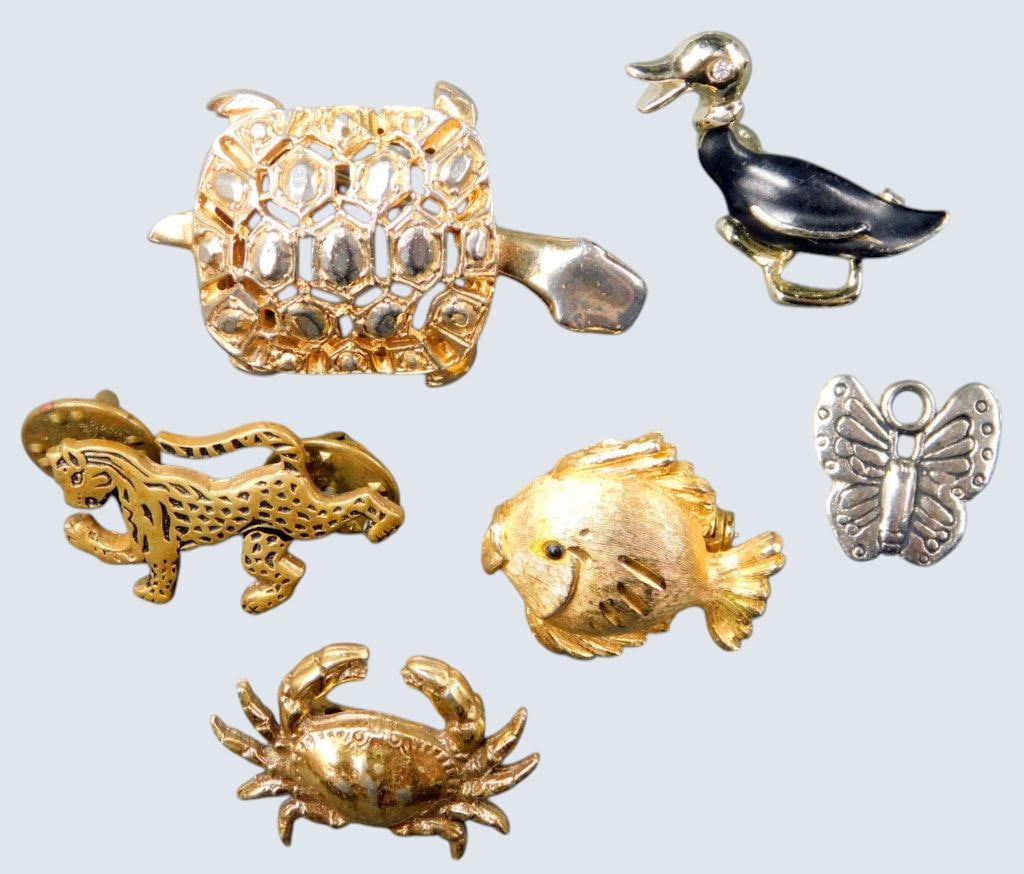 Animal-Themed Gold-Tone Brooches Including Hattie Carnegie, Pins and Charms, (6): Six animal-themed metal Brooches, pins, and charms Includes a sought after gold-plated turtle brooch by Hattie Carnegie, a gold-tone fish brooch marked JJ, a gold-tone crab brooch, a gold-tone duck