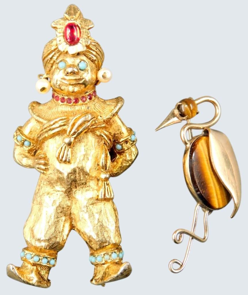 Gold-Tone Figural Brooch and Bird Pin w/ Tiger's Eye Stone: A gold-tone figural brooch, depicting a figure adorned with colorful turquoise accents, faux pearls, and a red cabochon centerpiece, it is missing the pinback; and a bird-shaped pin featuring tiger's