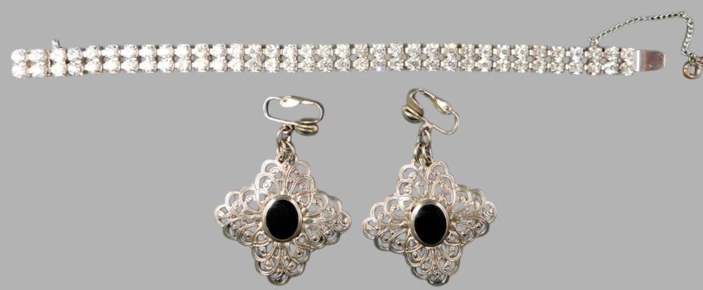 Kramer of N.Y. Rhinestone Bracelet and Filigree Clip-On Earrings Set: A rhinestone bracelet marked Kramer of N.Y. and a pair of ornate filigree clip-on earrings The bracelet features multiple rows of clear rhinestones set in a likely silver-tone setting, with a secure