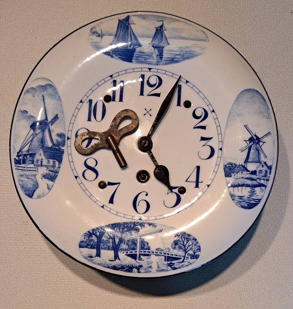 Antike Pfeilkreuz Küchenuhr um 1900: Alte antike Pfeilkreuz Emaille Küchenuhr Email weiß blau Ochsenauge Delft, Metallgehäuse, Zifferblatt emailliert um 1900, Pendeluhrwerk incl. Schlüssel, Maße ca. 27 x 9cm Interne Nr. A0171400416