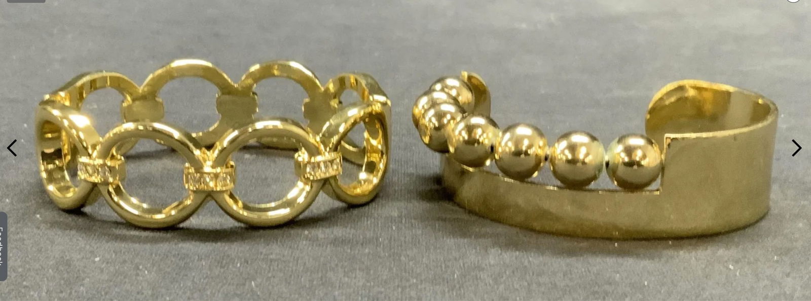 Gold Tone Beaded and Crystal Cuff Bracelets: Lot of 2 gold tone cuff bracelets. 1 hinged bracelet with open circle and crystal decoration. Measures approx. 2.25 inches wide. 1 beaded decorated cuff bracelet. Measures approx. 2.25 inches wide. Bo